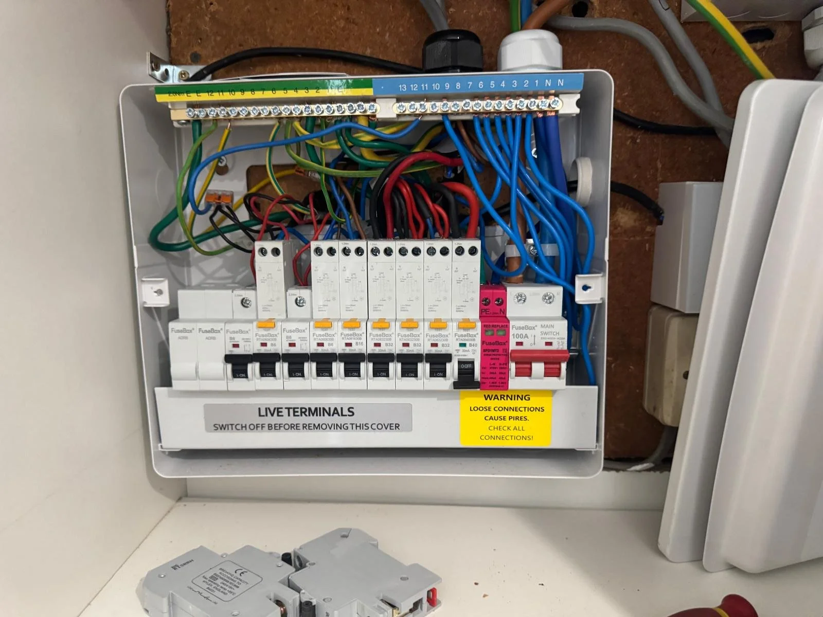 Pristine interior distribution layout of a dual RCD consumer unit upgrade showcasing geometric wire dressing.